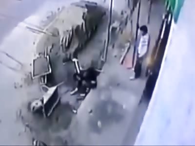 Wheelbarrow Falls from Height onto Worker.