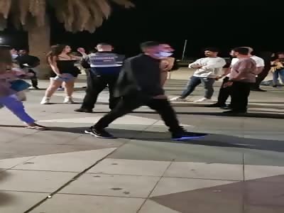 Very Angry naked woman argues with a cop.