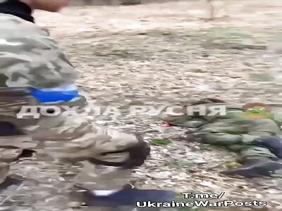 UA starting to dig a grave for a killed RU while laughin