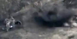 A munition explodes next to a group of RU soldiers