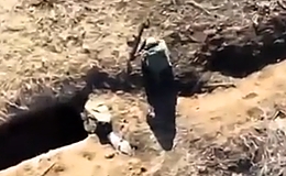 A drone hitting two RU soldiers with a grenade and artillery