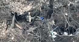 Drone view of Russian soldier looting his fallen comrades