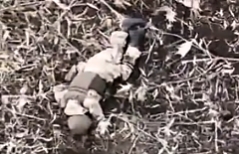 A crawling Russian soldier is hit and killed by a grenade