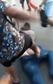 The thief is brutally beaten by the enraged mob