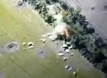 A shell explodes near a group of Russian soldiers