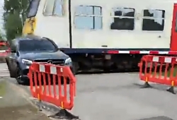 Absolute idiot gets hit by a train