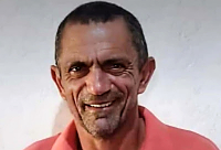 Hanged suicide decomposing on a tree