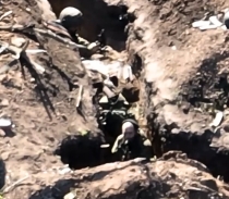 RU soldiers are shown trying to shoot down an observation drone