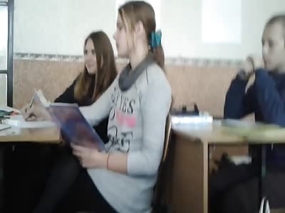 Cute teen girl vaping in classroom