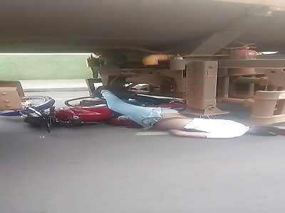 Motorcyclist dead under tanker.