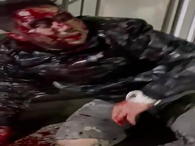 Kneeling man being tortured with machete