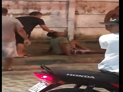 lynched robbers lying in the middle of the street