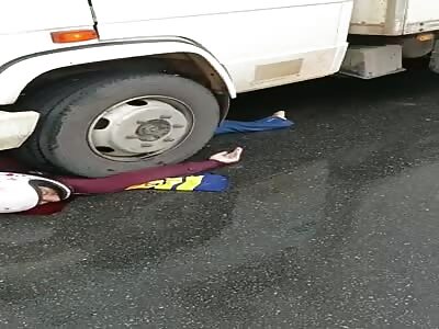 biker was trampled by a large 19 wheeler truck