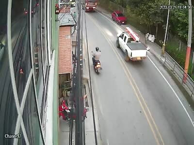 motorcyclist pressed roast between two trailers