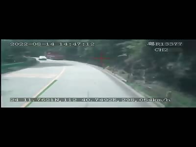 The woman's car was crushed between two cargo trucks.