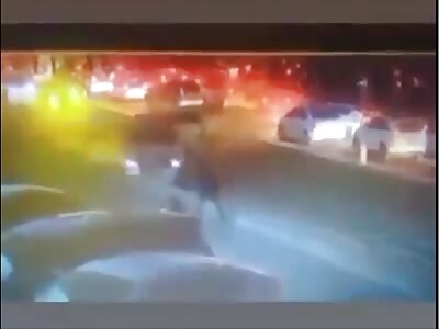 A female driver drags a pedestrian along a wall.
