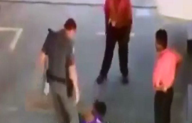 Thug intimidates gas station clerk On duty cop steps in