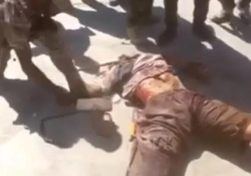 Daesh dead body and soldires having fun