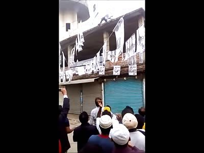 Electrocuted Man Falls from the Roof as the Crowd goes Wild 