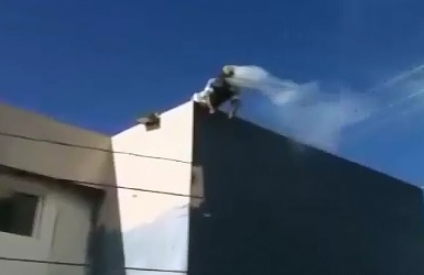 The Real Burning Man sits on his Rooftop just Staring out into Space 