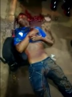 Another Thug Agonizes to Death in Front of Curious Crowd