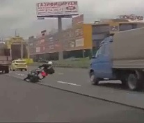 Biker Literally Just Falls over into Truck Wheel