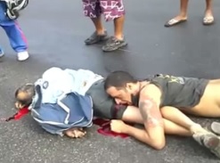 Guy is agonizing with head over his dead friend's butt