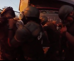 Riot police officer hit by molotov cocktail during Chile protests.