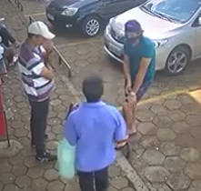 Female Driver Plays Sidewalk Bowling 