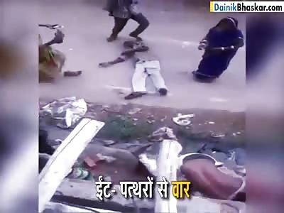 2GUYS BEING BEATEN WITH BAMBOO AND ROCKS