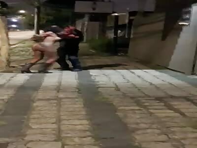 Naked transgender fights with client in the street.