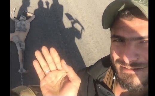 Guys Taking a Selfie while Daesh Member is Dragged Down the Road