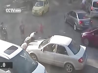 PEDESTRIANS LIFT CAR TO RESCUE WOMAN TRAPPED UNDERNEATH