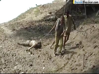 POLICE DRAGGING A DEAD BODY FROM THE RIVER TO THE ROAD