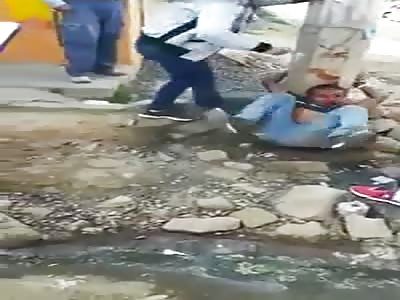 MAN TIED TO A POLE AND BEATEN