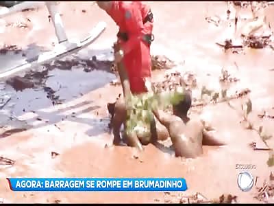 WOMAN BEING RESCUED AFTER DAM FAILURE