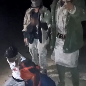 TWO BLINDFOLDED MEN BEING EXECUTED WITH GUNSHOT