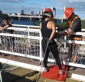 YOUNG MAN FALLING FROM FOOTBRIDGE