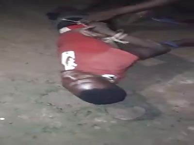 AFRICAN MAN BEING PUNISHED