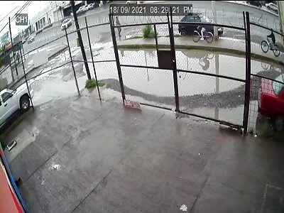 CAR SLIDES ON WET LANE AND RUNS OVER PASSERS