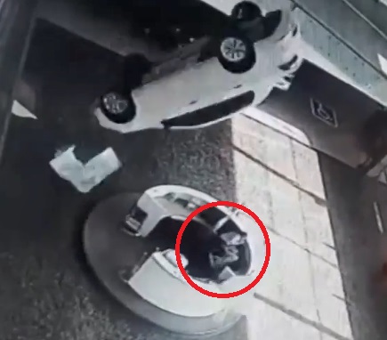 WOMAN SMASHED BY FALLING CAR