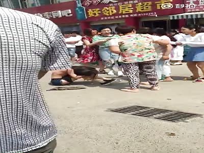 Topless woman stripped and beaten in Public.