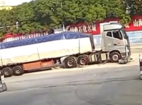 Motorcyclist gored under big loaded truck 