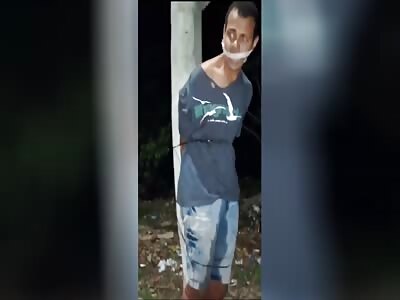 bloodied thief tied to pole being beaten