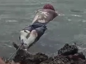 Dead body of a drowned man tied to the banks of the river 