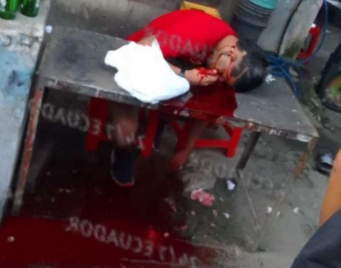 Young woman sitting on table executed by sicario 