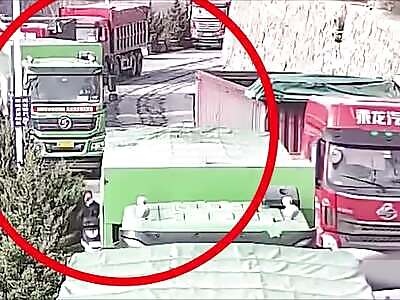 Drunk guy on scooter tries to squeeze between two trucks 