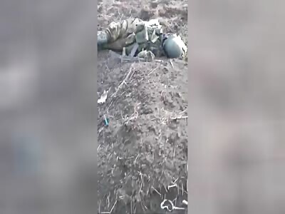 Russian soldier showing his dead comrades 