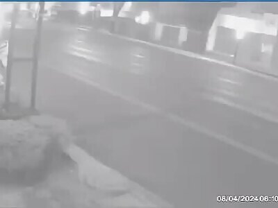 Coffee vendor riding down the street gets taken out by ambulance. 