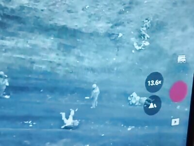 Russians carry away their dead comrades from the battlefield